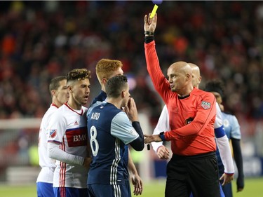 Vancouver Whitecaps Fraser Aird is given a yellow card by referee Robert Sibiga during the second half of MLS action in Toronto on Saturday, May 14, 2016.
