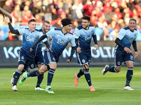 Vancouver Whitecaps midfielder Christian Bolanos (7) celebrates his goal against Toronto FC during the first half of MLS action in Toronto on May 14. Pedro Morales is second from right.