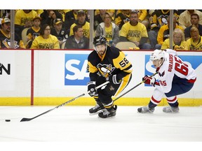 Kris Letang of the Pittsburgh Penguins handles the puck in front of Andre Burakovsky of the Washington Capitals in Game 3 Monday. Getty Images
