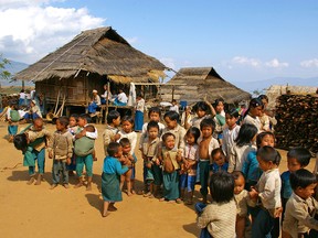 Village of LAHU-SHI people. Village on mountaintop and all villagers wear white and blue. These children do not go to school.