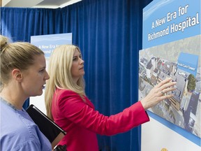 Chief Operating Officer for Richmond Hospital Jennifer MacKenzie (right) explains the plan for a new acute care tower for Richmond Hospital to a nurse.