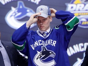 Olli Juolevi celebrates with the Vancouver Canucks after being selected fifth overall during the first round of the 2016 NHL Draft in Buffalo, N.Y., on Friday.