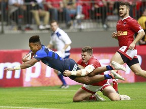 VANCOUVER, BC - JUNE 11:  Jamie Mackenzie #22 of Canada tries to tackle Kotaro Matsushima #15 of Japan as he scores the winning try during their match at BC Place on June 11, 2016 in Vancouver, Canada.  Japan won 26-22.