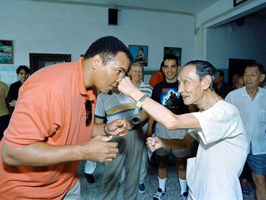 (FILES) This file photo taken on September 01, 1994 shows Boxing great Muhammad Ali receiving a punch from a 79 old "sparring-partner" during a visit in a old people's home in Macau. Boxing legend Muhammad Ali, dies at 74. The former heavyweight world champion was hospitalized on Thursday at a Phoenix, Arizona, hospital with a respiratory issue, which US media reported was complicated by his Parkinson's disease.  / AFP PHOTO / Mike FialaMIKE FIALA/AFP/Getty Images