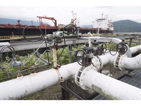 A ship receives a load of oil from the Kinder Morgan Trans Mountain loading dock in Burnaby, B.C., in this June 4, 2015, file photo. The election of pro-pipeline Republican Donald Trump last week doesn’t reduce the Trudeau’s government’s desire to help Alberta get its diluted bitumen to Asian markets via the B.C. coast, Natural Resources Minister Jim Carr said Tuesday.