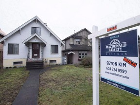 A sold home is pictured in Vancouver, B.C., Thursday, Feb. 11, 2016. Canada Mortgage and Housing Corporation says there is mounting evidence that house prices in a number of Canadian cities are out of whack with incomes and other economic fundamentals.The latest report from CMHC says there is evidence of overvaluation in nine of the 15 real estate markets included in the research.