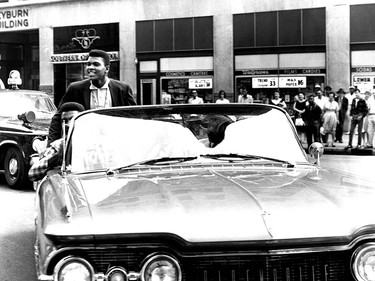 Local Input~ FILE  ** Boxer Cassius Clay, upper left, returns from the Olympics to Louisville, as he rides in a convertible that's turning onto 4th Street from Broadway, Sept. 9, 1960. He was a shy, well-mannered kid who babysat for neighbors and shadow-boxed with the cigar tree in the front yard of his childhood home.  And even when Clay won the heavyweight championship, changed his name to Muhammad Ali and became one of the world's most recognized figures, close friends saidhe never lost his bond to the west Louisville neighborhood where he grew up. (AP Photo/The Courier Journal, Al Hixenbaugh) ORG XMIT: POS2016060315220155 ORG XMIT: POS1606031523435840      Muhammad Ali options ORG XMIT: POS1606031709110300