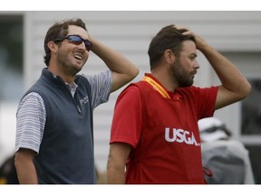 Andrew Landry, left, and his caddie Kevin Ensor react after completing the rain delayed first round of the U.S. Open golf championship at Oakmont Country Club on Friday, June 17, 2016, in Oakmont, Pa.
