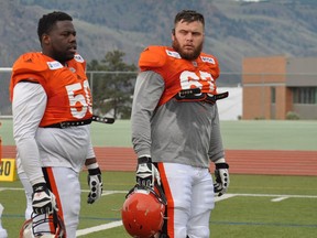 B.C. Lions offensive linemen Kirby Fabien (left) and Hunter Steward take a break during the CFL team's training camp in Kamloops.