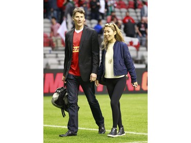 VANCOUVER, BC - JUNE 11:  Vancouver mayor Gregor Robertson and his rock star girlfriend Wanting Qu leave the Men's International Rugby match between Canada and Japan at BC Place on June 11, 2016 in Vancouver, Canada.  Japan won 26-22.