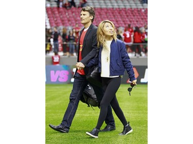VANCOUVER, BC - JUNE 11:  Vancouver mayor Gregor Robertson and his rock star girlfriend Wanting Qu leave the Men's International Rugby match between Canada and Japan at BC Place on June 11, 2016 in Vancouver, Canada.  Japan won 26-22.