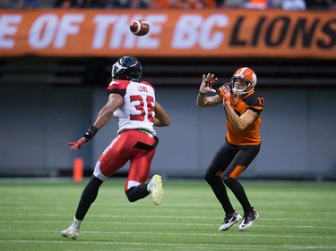 B.C. Lions' Nick Moore, right, makes a reception as Calgary Stampeders' Glenn Love defends during the first half of a pre-season CFL football game in Vancouver, B.C., on Friday June 17, 2016. THE CANADIAN PRESS/Darryl Dyck ORG XMIT: VCRD120