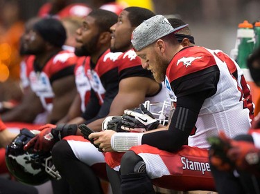 Calgary Stampeders' quarterback Bo Levi Mitchell watches game footage on an iPad while sitting on the bench during the second half of a pre-season CFL football game against the B.C. Lions in Vancouver, B.C., on Friday June 17, 2016. THE CANADIAN PRESS/Darryl Dyck ORG XMIT: VCRD128