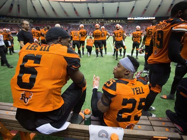 B.C. Lions' T.J. Lee, left, and Ronnie Yell talk while sitting on the bench during the second half of a pre-season CFL football game against the Calgary Stampeders in Vancouver, B.C., on Friday June 17, 2016. THE CANADIAN PRESS/Darryl Dyck ORG XMIT: VCRD132