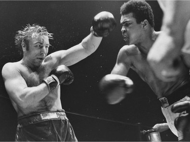 FILE PHOTO - Muhammad Ali pounds George Chuvalo during a fight on May 1, 1972 at the Pacific Coliseum