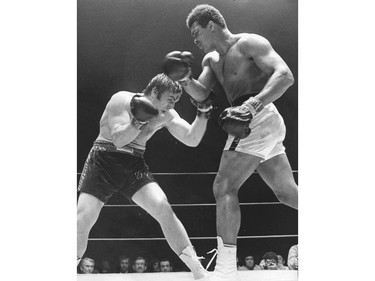 FILE PHOTO - Muhammad Ali pounds George Chuvalo during a fight on May 1, 1972 at the Pacific Coliseum