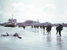 Troops of the 3rd Canadian Infantry Division land at Juno Beach on the outskirts of Bernieres-sur-Mer, France on D-Day, June 6, 1944. With a composite image of the beach today. Peter Macdiarmid and Galerie Bilderwelt/Getty Images