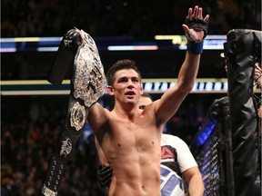 Dominick Cruz celebrates with the title belt after his win against TJ Dillashaw in a UFC bantamweight title match in January in Boston. Cruz regained the UFC bantamweight title Sunday night, outpointing Dillashaw by split decision.