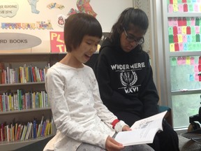 Dorothy Guan (left) reads Mia, Matt and the Turkey Chase with a little help from Mohini Takhar. The two met in the Vancouver Public Library's Reading Buddies program.