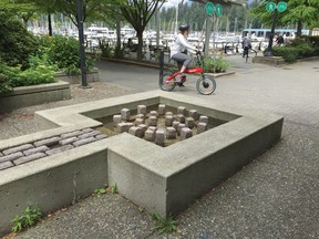 A cyclist heads along the Seawall on the Seaside Bikepath in Coal Harbour.