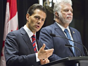 Mexico President Enrique Pena Nieto and Quebec Premier Philippe Couillard attend a press conference in Quebec City, Monday, June 27, 2016.