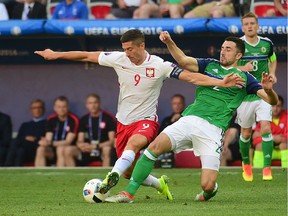Poland forward Robert Lewandowski, left, battles with Northern Ireland's defender Conor McLaughlin during the Euro 2016 group C football match between Poland and Northern Ireland at the Allianz Riviera stadium in Nice earlier this week. Lewandowski will be facing a number of his club teammates from Bayern Munich when Poland takes on Germany.