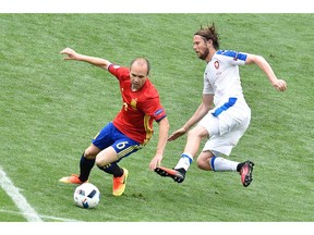 Spain's midfielder Andres Iniesta (L) dribbles past Czech Republic's midfielder Jaroslav Plasil during the Euro 2016 group D football match between Spain and Czech Republic at the Stadium Municipal in Toulouse on June 13, 2016.