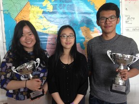 From left, students Emily Yeung, Heidi Suen and Chris Zhu with the trophies they won at the Vancouver regional round of World Scholar's Cup.