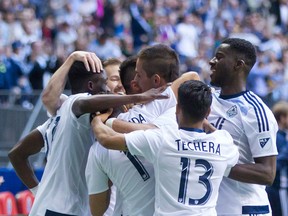 Vancouver Whitecaps' Octavio Rivero, centre, is mobbed by his teammates in celebration after scoring against the Ottawa Fury during second half semifinal Canadian Championship soccer action in Vancouver.