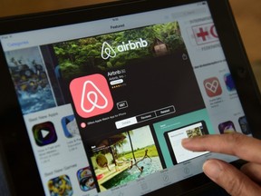 A woman browses the site of home sharing giant Airbnb on a tablet in Berlin, Germany, earlier this year. Airbnb guests — who have been shown to spend more money, stay longer, stay outside hotel districts and visit establishments that don't usually see tourist traffic — can extend and distribute the economic benefit associated with big events, says Jeff Duncan of Meetingmax.