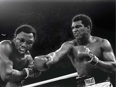FILE - In this Oct. 1, 1975, file photo, spray flies from the head of Joe Frazier as Muhammad Ali connects with a right in the ninth round of their title fight in Manila, Philippines, Ali won the fight on a decision to retain the title. The two fought three times, including two of the most famous matches ever. (AP Photo/Mitsunori Chigita, File) ORG XMIT: POS2016060315210975      Muhammad Ali options ORG XMIT: POS1606031709190310