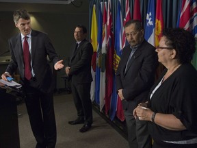 Vancouver Mayor Gregor Robertson gestures to Chief Maureen Thomas of the Tsleil-Waututh Nation as Chief Ian Campbell (centre-left) of the Squamish Nation and hereditary Chief and councillor Howard Grant (centre-right) on behalf of the Musqueam Nation look on during a news conference on Parliament Hill in Ottawa on Tuesday.