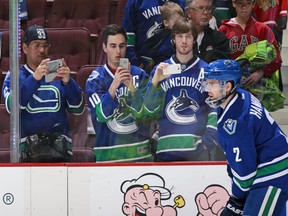 Canucks fans take photos of Dan Hamhuis.