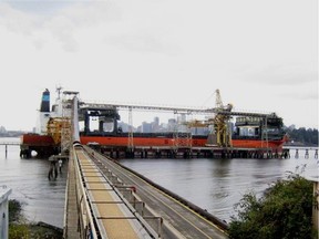 A ship loading B.C.-made wood pellets for export to be used in biomass-power generation.