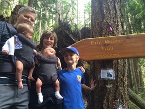 Michael and Elizabeth Moore with their son Cameron and infant twins at the head of a new trail in Lions Bay dedicated to their late daughter Erin.