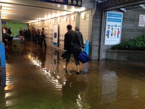 Flooding at the Coquitlam West Coast Express train station early Tuesday didn't stop commuters from kicking off their shoes and rolling up their pants to wade through the water to get to work.