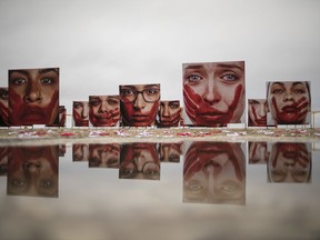 The anguish of sexual assault survivors is captured by photographer Marcio Freitas' 'I'll Never Be Silenced' displayed on a Brazilian beach.