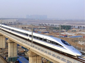 In this photo released by China's Xinhua news agency, a bullet train passes over Yongdinghe Bridge in Beijing Wednesday, Dec. 26, 2012. With affordable homes now as far out of Vancouver as Chilliwack and Hope is it time to start talking about a high speed train connecting Vancouver and the Fraser Valley?