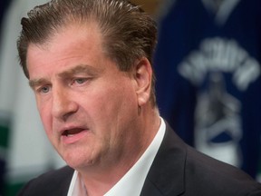 In this Sept. 17, 2015, file photo, Vancouver Canucks general manager Jim Benning speaks during an NHL hockey news conference in Vancouver, British Columbia.The Vancouver Canucks will pay for general manager Benning's candid comments.The club was fined US$50,000 by the NHL on Tuesday afternoon for tampering, a violation of by-law 15.