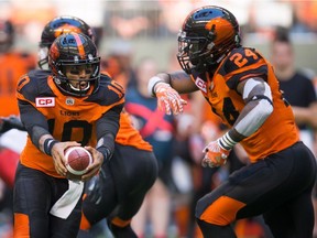B.C. Lions' quarterback Jonathon Jennings fakes a handoff to running back Jeremiah Johnson on Saturday at B.C. Place. Jennings and Johnson both had strong second half performances as the Lions came from behind to beat the Calgary Stampeders 20-18.