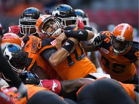 B.C. Lions quarterback Jonathon Jennings, centre, carries the ball for a first down against the Calgary Stampeders during the first half of a pre-season CFL football game in Vancouver, B.C., on Friday June 17, 2016.