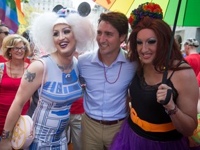 Liberal Leader Justin Trudeau stands for a photo with revellers before marching in the Vancouver Pride Parade speaks in Vancouver, B.C., on Sunday August 2, 2015. A federal election will be held on October 19.