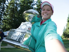 Brooke Henderson of Canada poses for a simulated selfie with the trophy after winning the KPMG Women's PGA Championship in a playoff against Lydia Ko at Sahalee Country Club earlier this month in Sammamish, Washington.