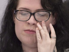 Julia Lamb, who has a degenerative muscle disease, pauses during a news conference in Vancouver, B.C., Monday, June, 27, 2016. Lamb is challenging Canada's physician-assisted dying law just days after it came into force.