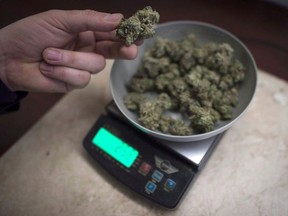 Marijuana is weighed at a medical marijuana dispensary, in Vancouver, Wednesday, Feb. 5, 2015.Vancouver medical marijuana businesses that are operating without a licence must close by Friday.The city says inspectors will start enforcing regulations on compassion clubs and retail stores that have not complied with the rules but were allowed to remain open past a six-month grace period.