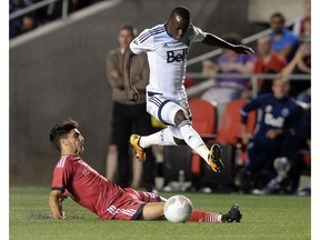 Ottawa Fury FC's Mauro Eustaquio, bottom, kicks the ball away from Vancouver Whitecaps' Kekuta Manneh during the second half of Amway Canadian championship semi-final soccer action in Ottawa on Wednesday, June 1, 2016.