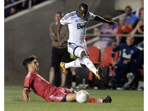 Ottawa Fury's Mauro Eustaquio, bottom, kicks the ball away from Vancouver Whitecaps' Kekuta Manneh on Wednesday in Ottawa. The Fury won 2-0.