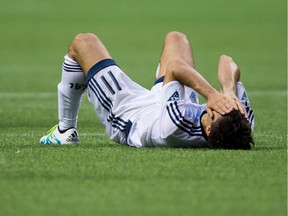 Vancouver Whitecaps' Nicolas Mezquida lies on the field after losing the Canadian Championship soccer final to Toronto FC on aggregate in Vancouver, B.C., on Wednesday June 29, 2016.