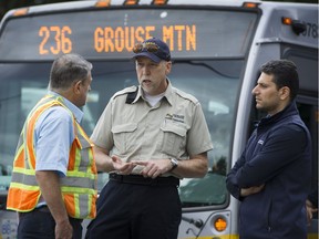 Dave McKay, centre, works for TransLink as a "defuser" -- a person trained in conflict resolution to help bus drivers cope with traumatic situations. He chats with bus drivers Rod Paracy (left) and Farva Abadeh.