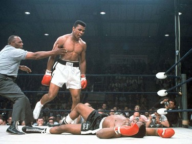 FILE - In this May 25, 1965, file photo, heavyweight champion Muhammad Ali is held back by referee Joe Walcott, left, after Ali knocked out challenger Sonny Liston in the first round of their title fight in Lewiston, Maine.  Ali, the magnificent heavyweight champion whose fast fists and irrepressible personality transcended sports and captivated the world, has died according to a statement released by his family Friday, June 3, 2016. He was 74. (AP Photo/File) ORG XMIT: NY203